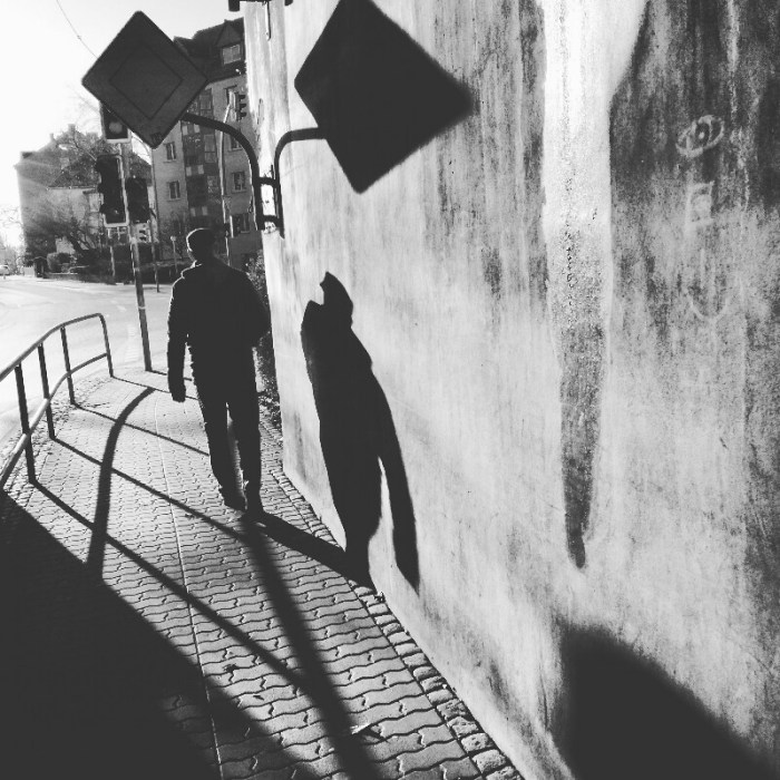 Street photo of a man underneath Angermünde train bridge