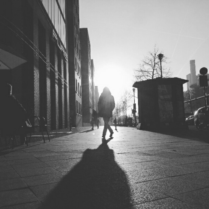 Black and white street photo of backlid silhouette near Potsdamer Platz