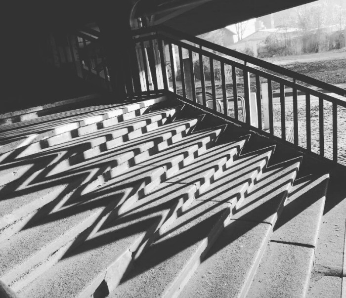 Black and white street photo of geometric shadowlines  at train station Schöneberg, Berlin