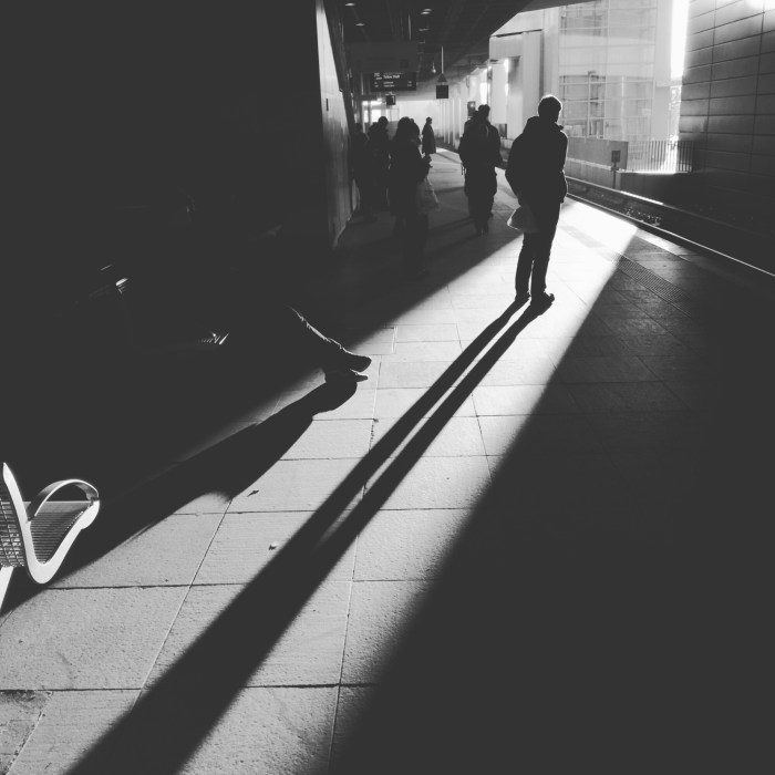 Man waiting in a narrow spot of sun light at Südkreuz Station, Berlin