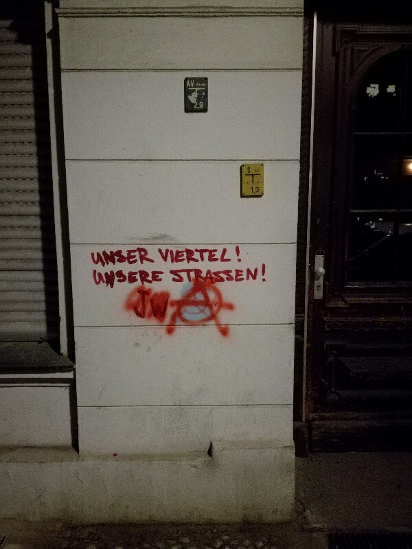 Grafitti on a Berlin Neukölln house saying: “Our quarter - our streets“ 