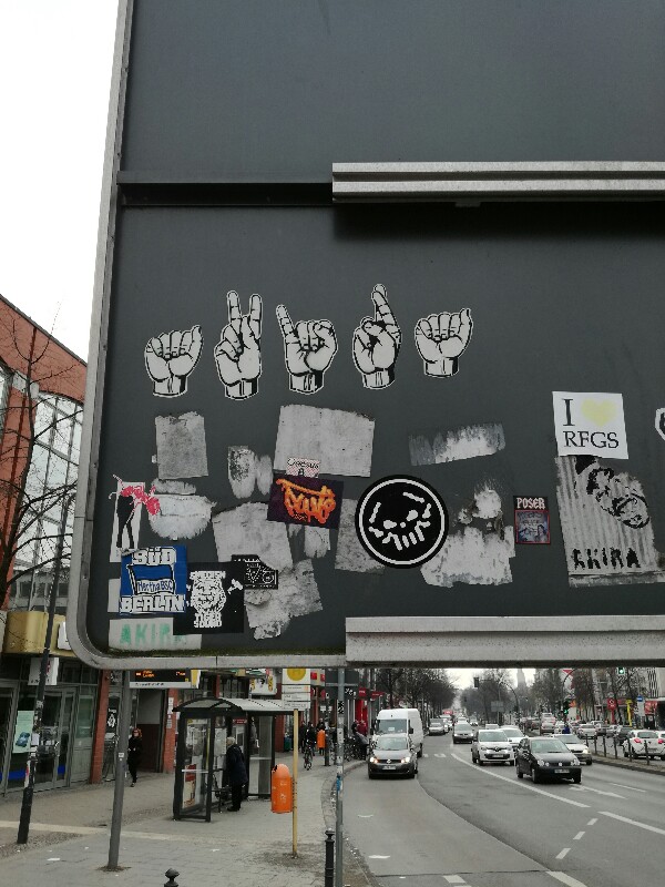 Street Photo of a Sign Language Street Art on the back of a traffic sign (Photo by Stefan Klenke)